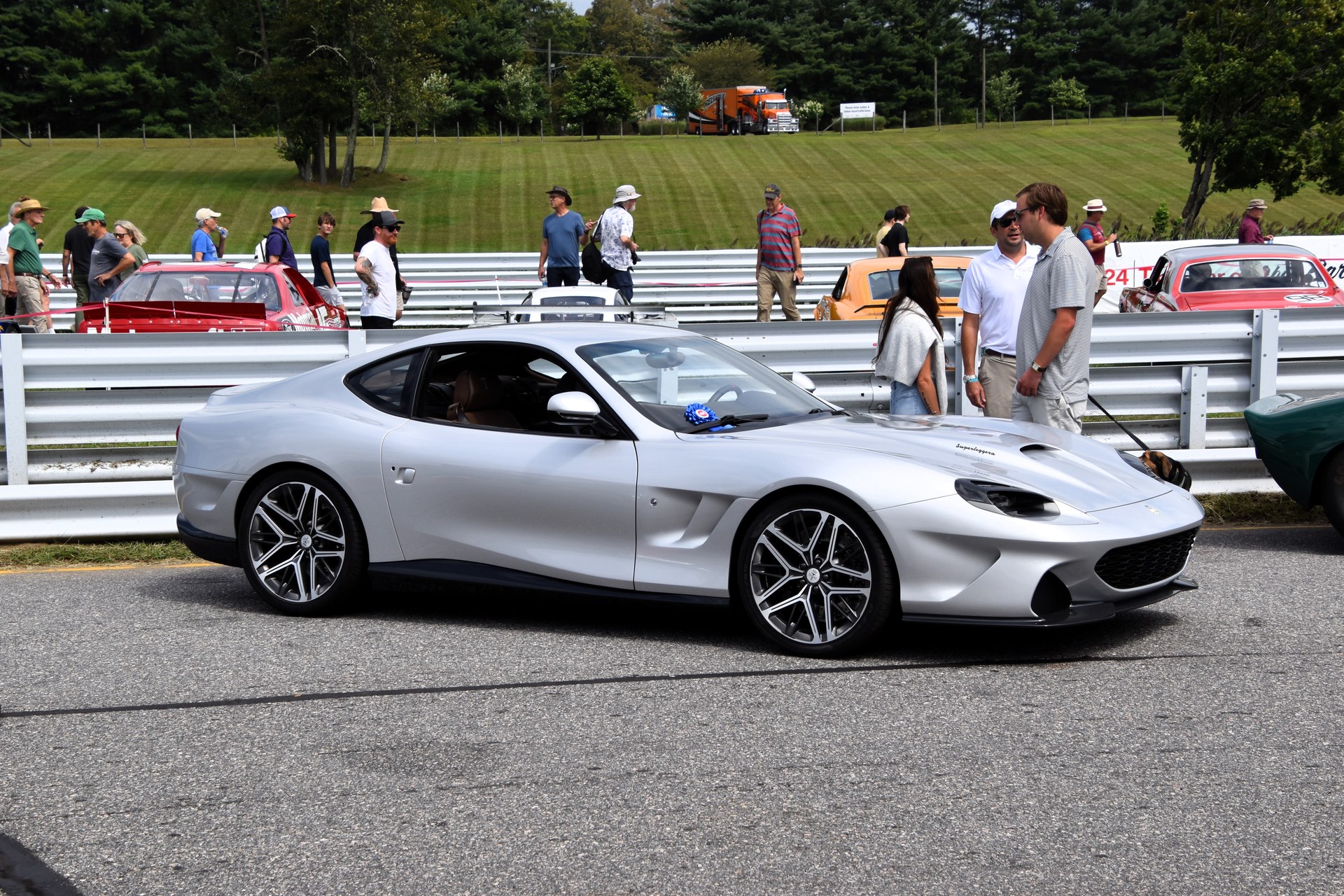Silver Touring Superleggera Veloce12 coupe in profile at an outdoor car show