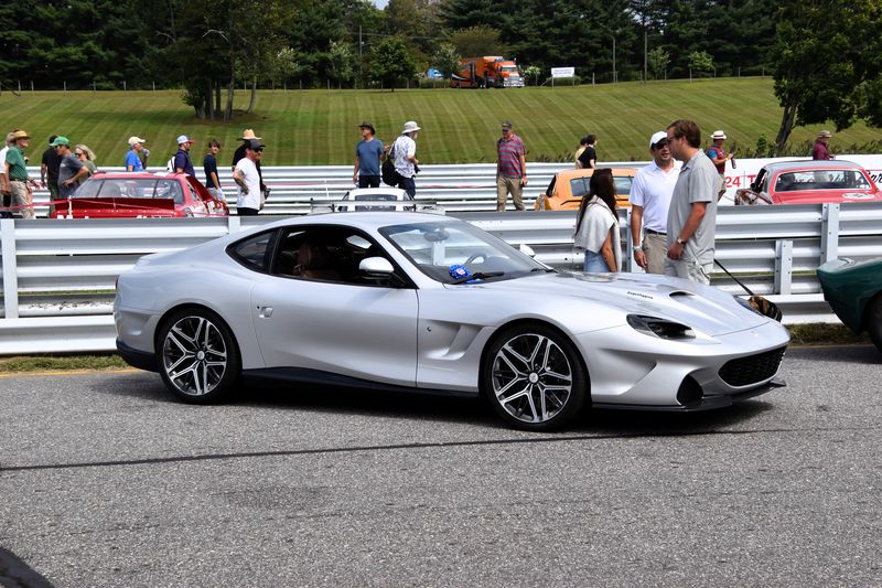 Silver Touring Superleggera Veloce12 coupe in profile at an outdoor car show