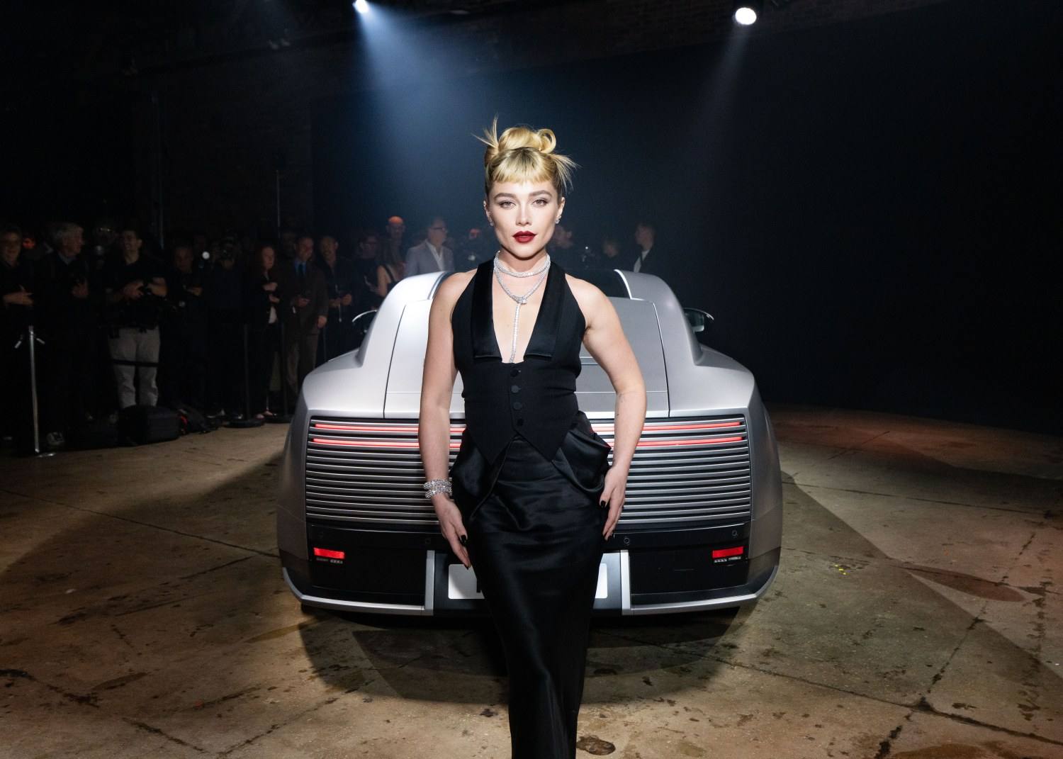 Florence Pugh standing with the Jaguar Type 01 at the New York reveal event