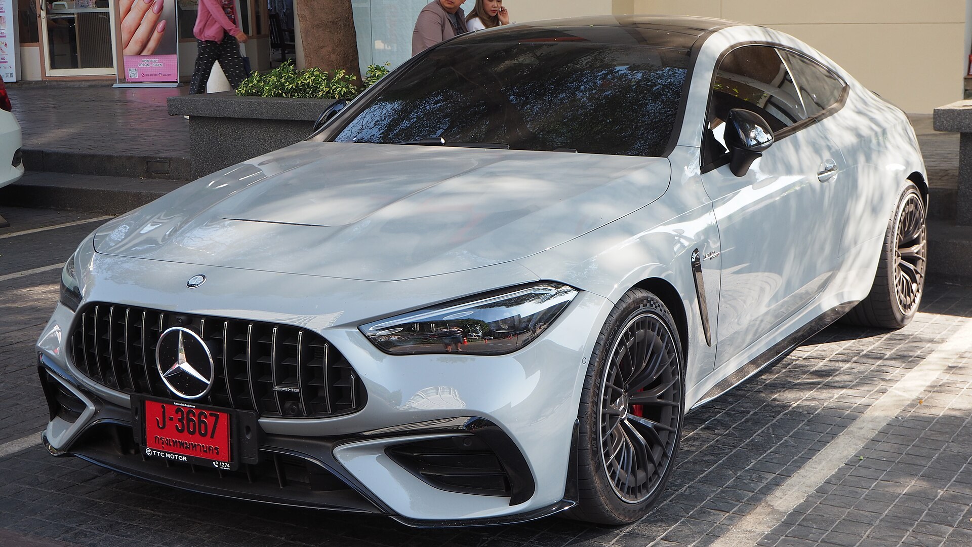 White Mercedes-AMG CLE 53 coupe parked on a street