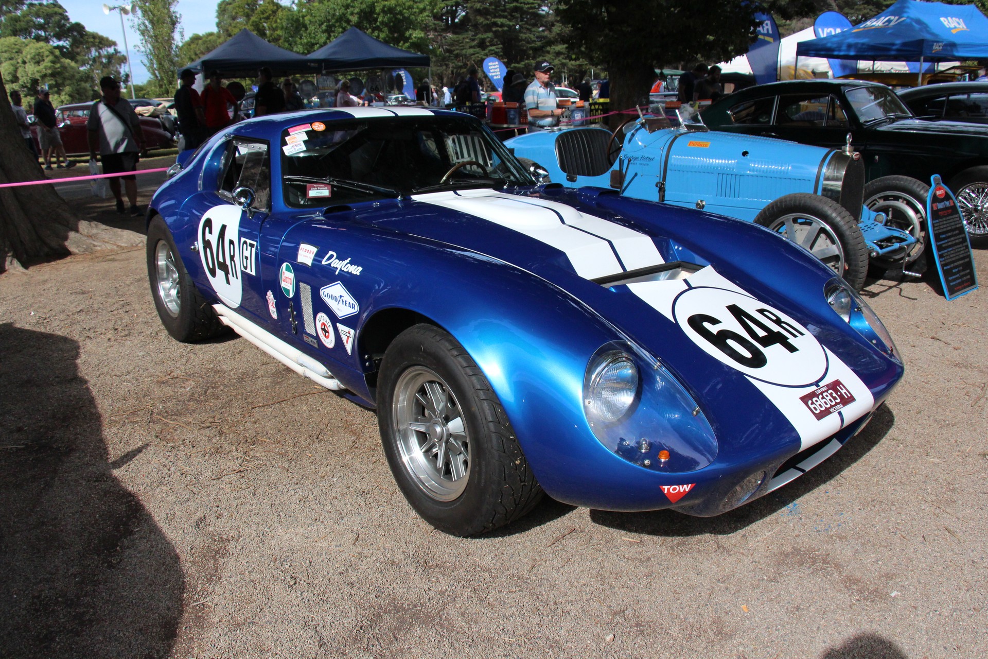 Blue and white 1964 Shelby Cobra Daytona Coupe CSX2287 in front three-quarter view at a car show